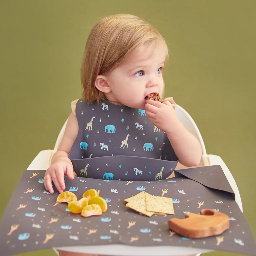 faded black feeding bib and placemat in safari animal print