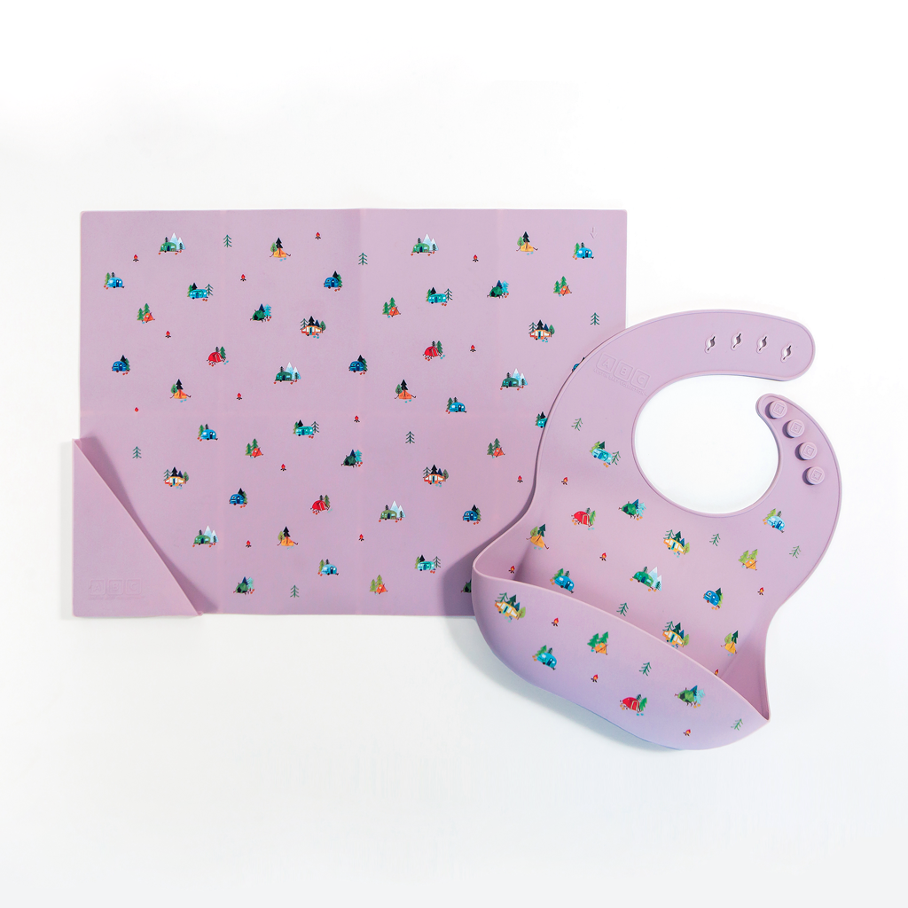 violet silicone placemat in camping print, with matching feeding bib