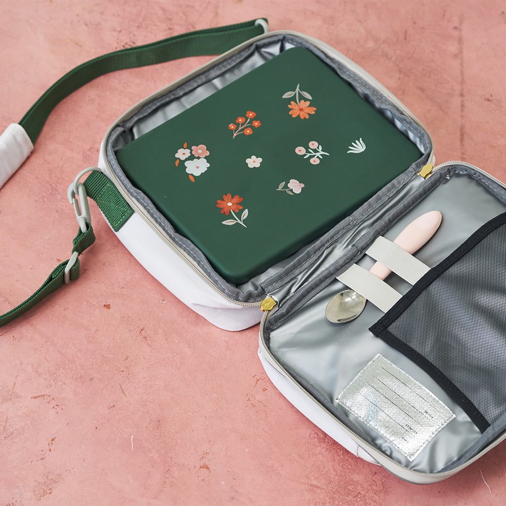 green bento box in white lunch bag