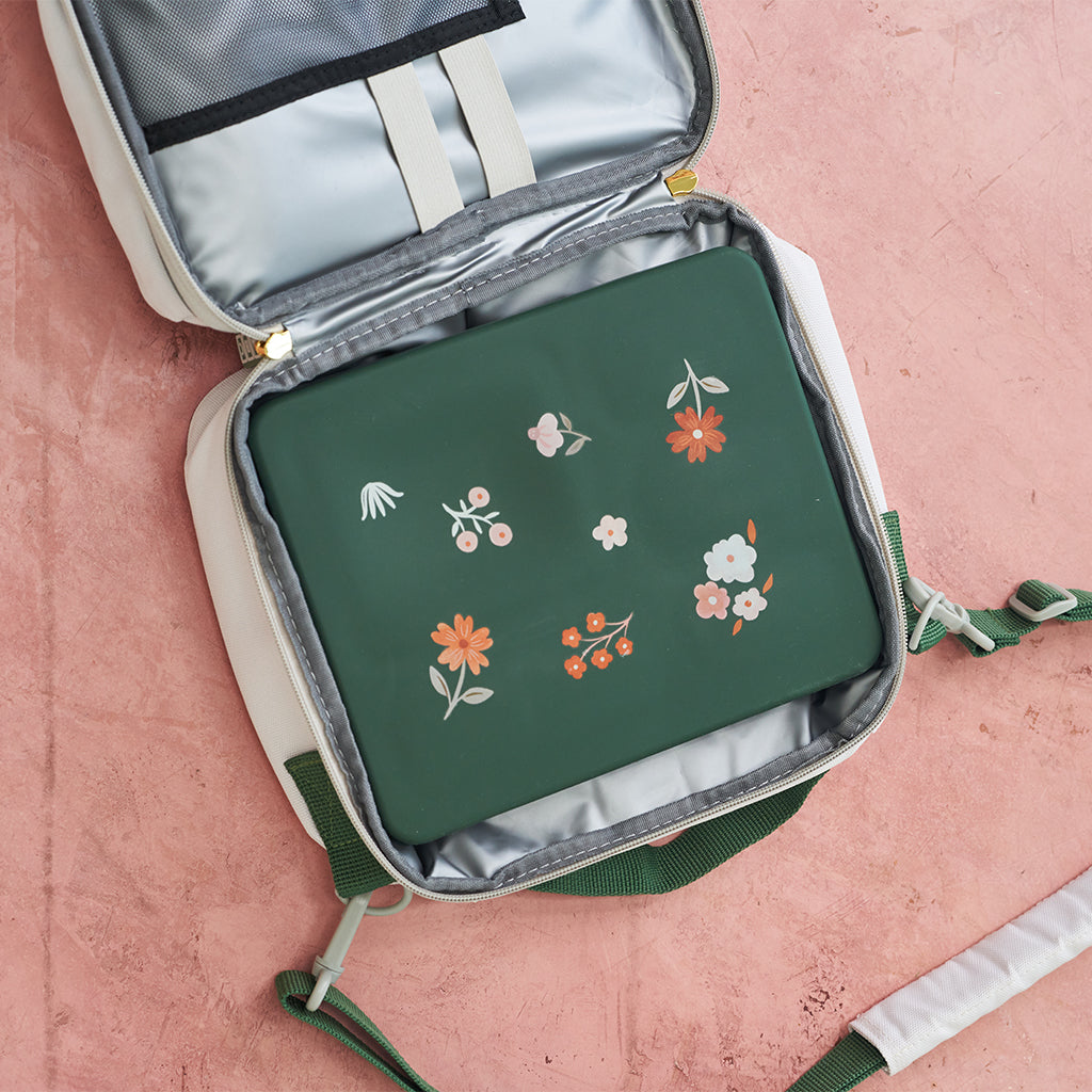 green bento box in white lunch bag