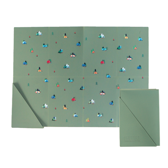 green silicone placemat in camping print, shown folded and unfolded