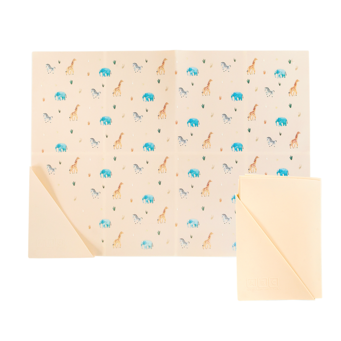 cream silicone placemat in safari animal print, shown folded and unfolded