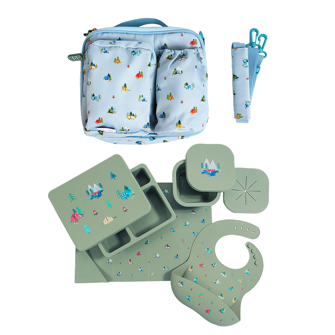 blue lunch bag in camping print with green silicone lunch bento box, placemat, snack bowl, and feeding bib in camping print