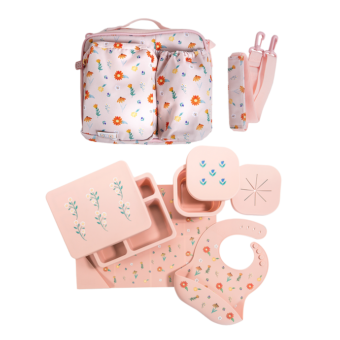 pink lunch bag, silicone lunch bento box, snack bowl, placemat, and bib in wildflower print