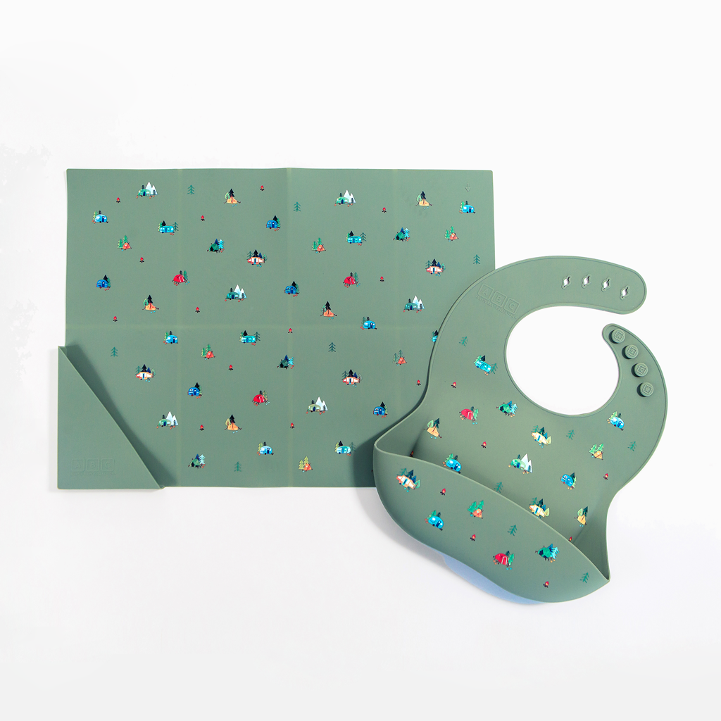 green silicone placemat in camping print, with matching feeding bib