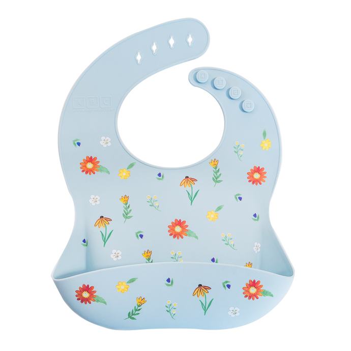 light blue silicone feeding bib with front pocket in wildflower print