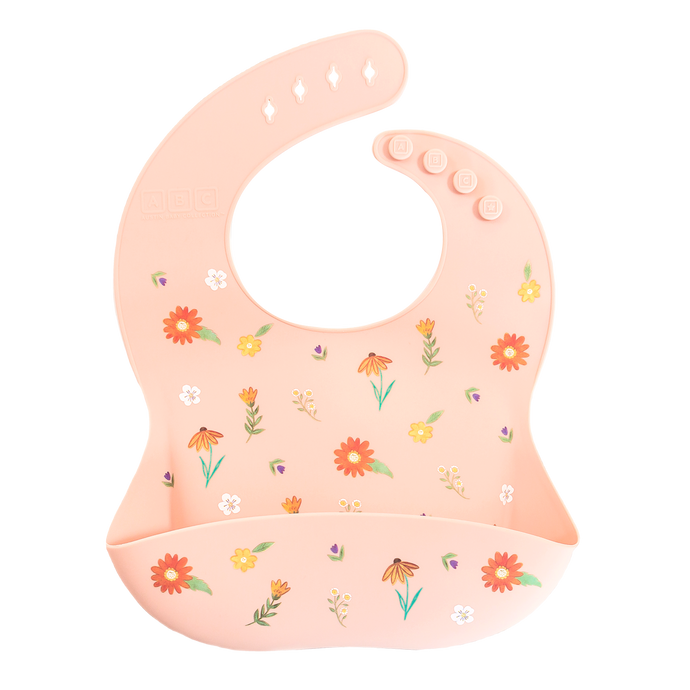 pink silicone feeding bib with front pocket in wildflower print