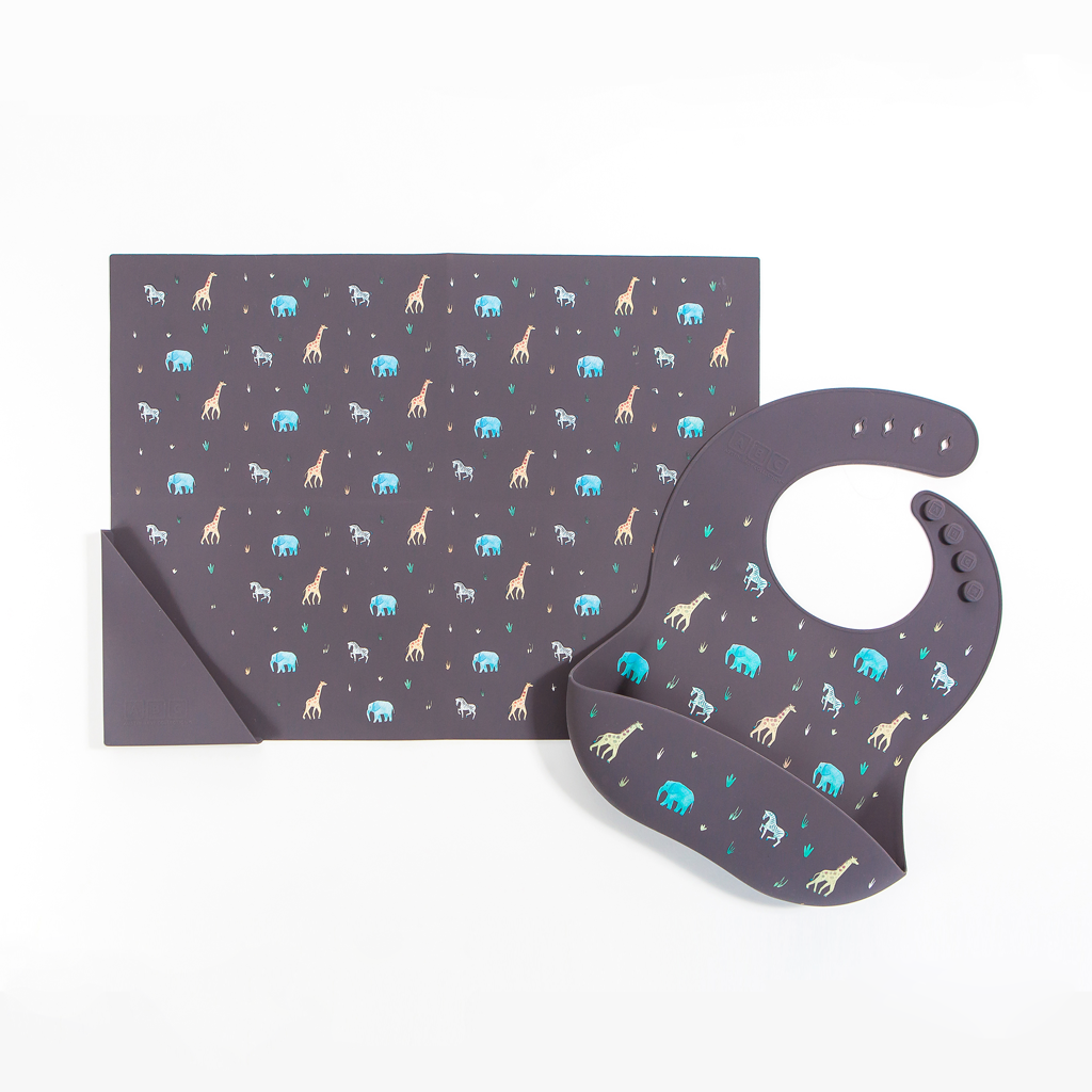 faded black silicone feeding bib with front pocket in safari animal print, with matching silicone placemat