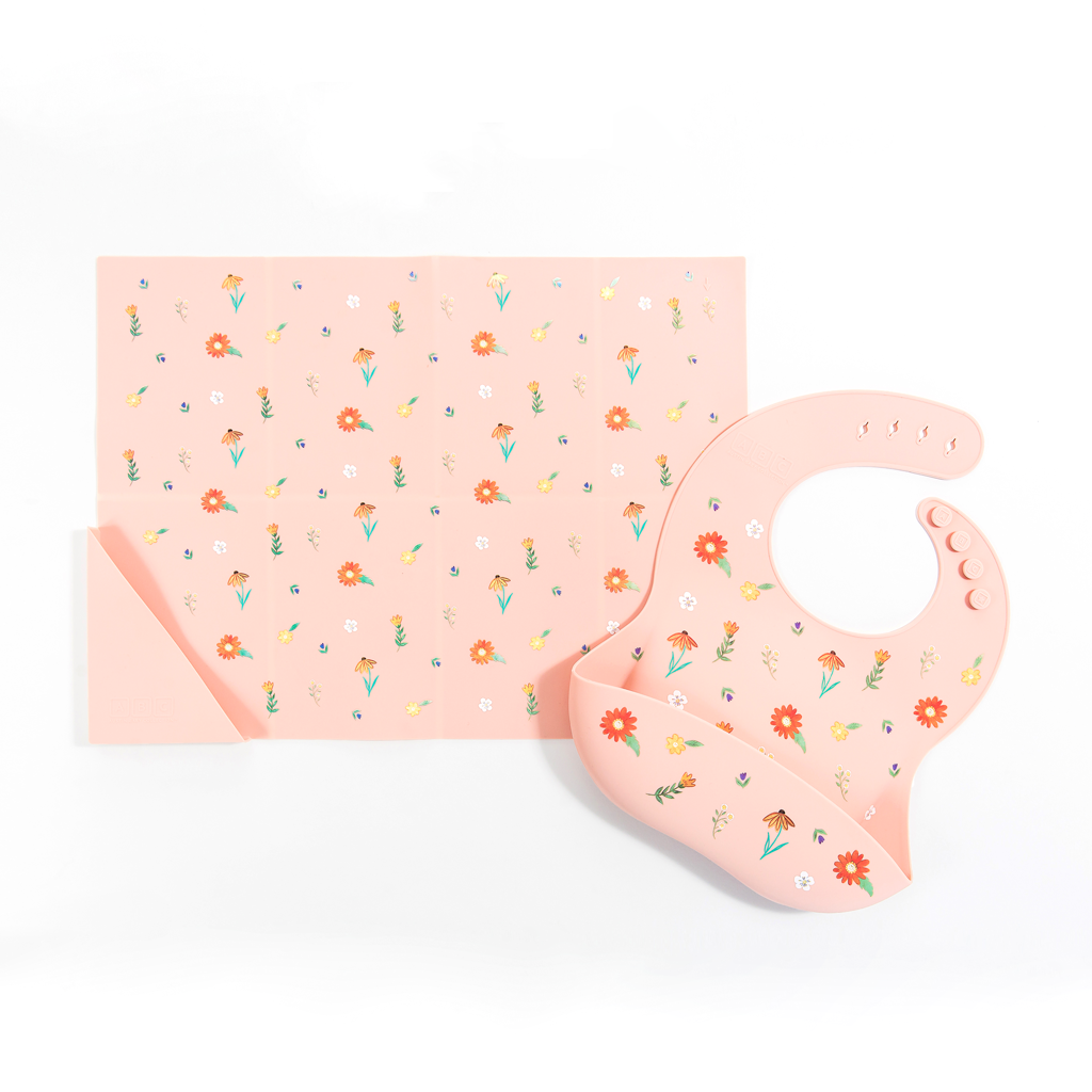 pink silicone placemat in wildflower print, with matching feeding bib